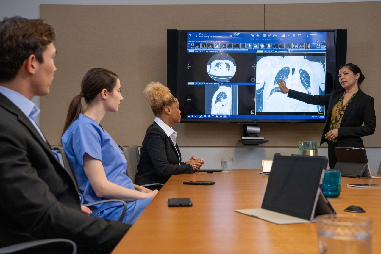 Conference room discussion with x-ray on screen